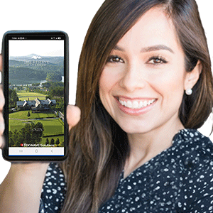 Property manager holding phone with TEKWave branded mobile app showing HOA community access