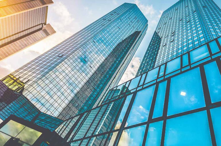 Modern glass office buildings representing TEKWave Remote Guarding solutions for commercial properties